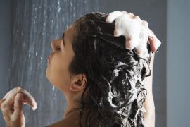 Femme sous la douche qui se fait un shampooing